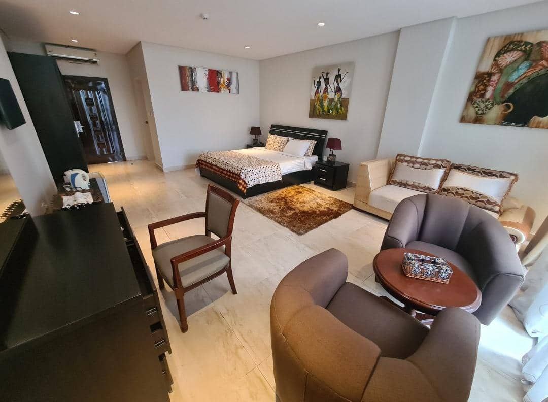 A living room with a couch, chair, and a tv